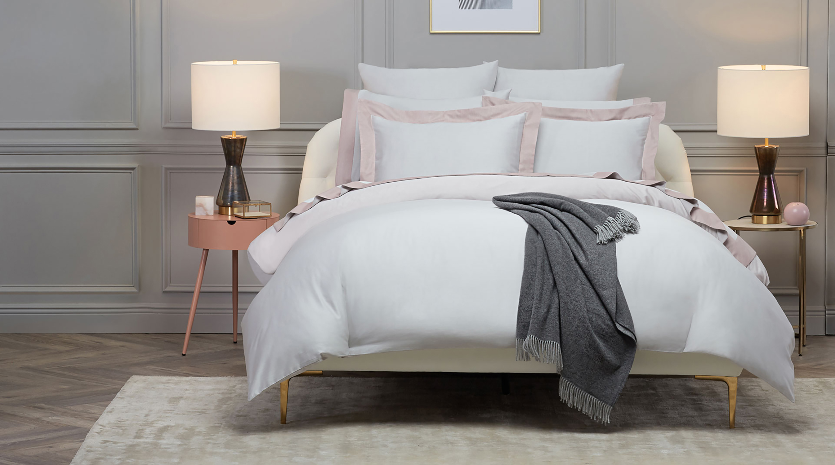 A bed that has been professionally styled by a photo stylist