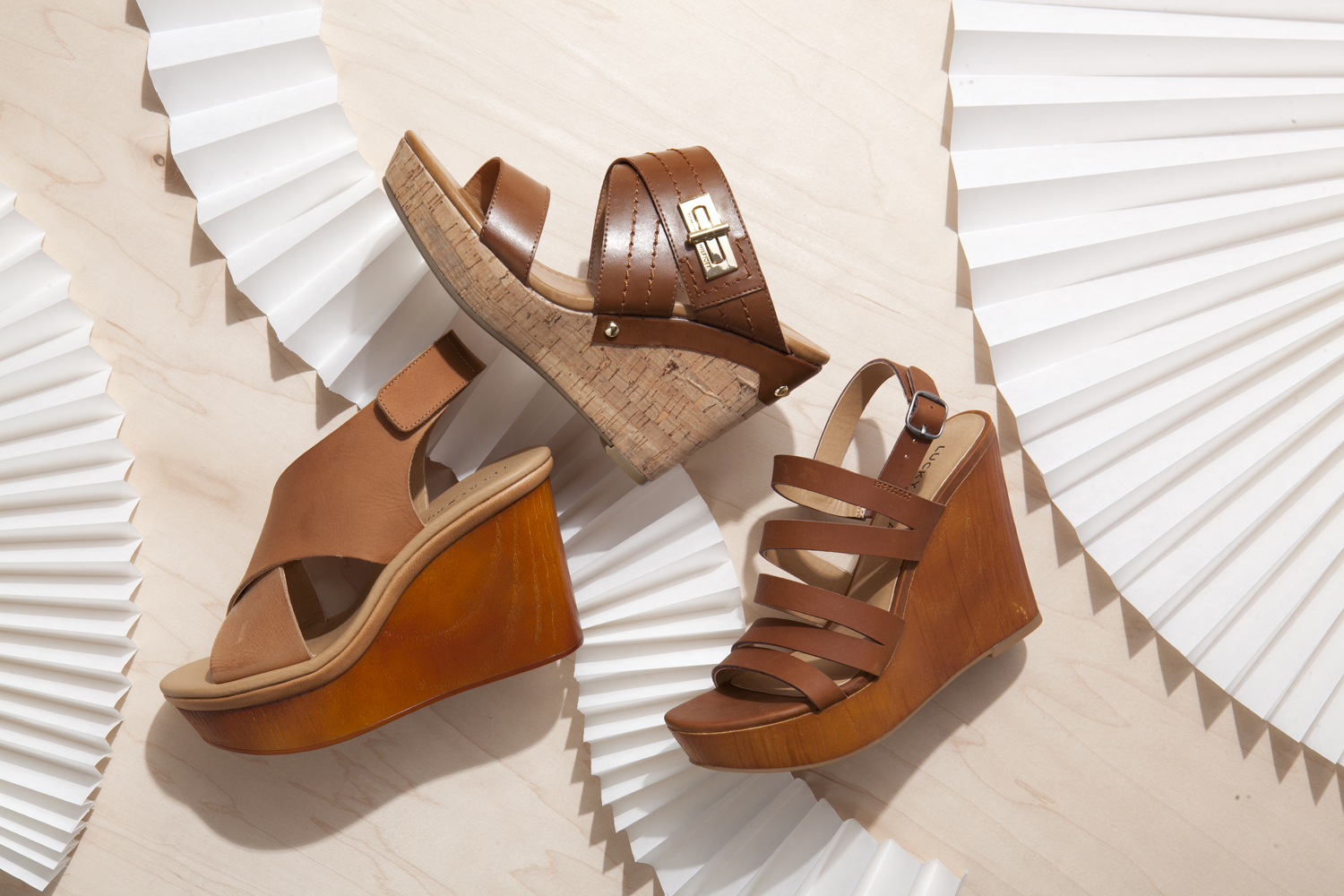 Assorted brown sandals that have been styled by a footwear photo stylist