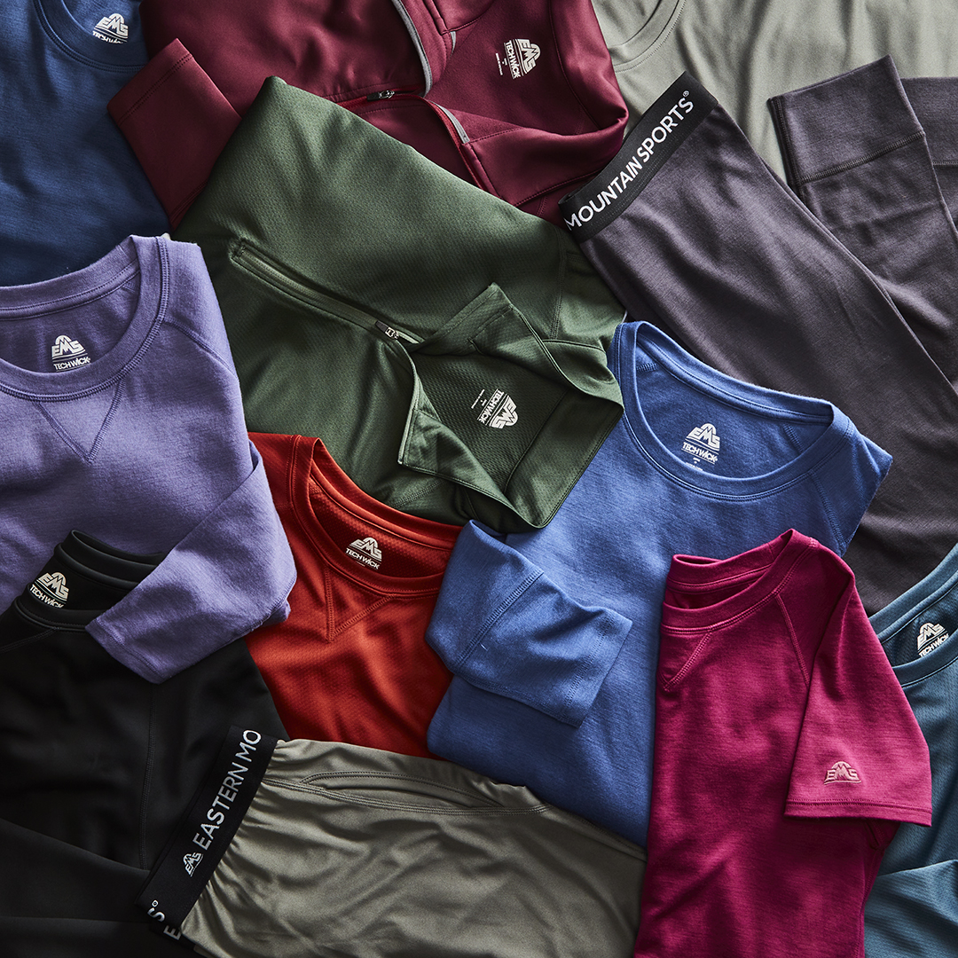 Assorted eastern mountain sports clothing items professionally displayed by an apparel photo stylist