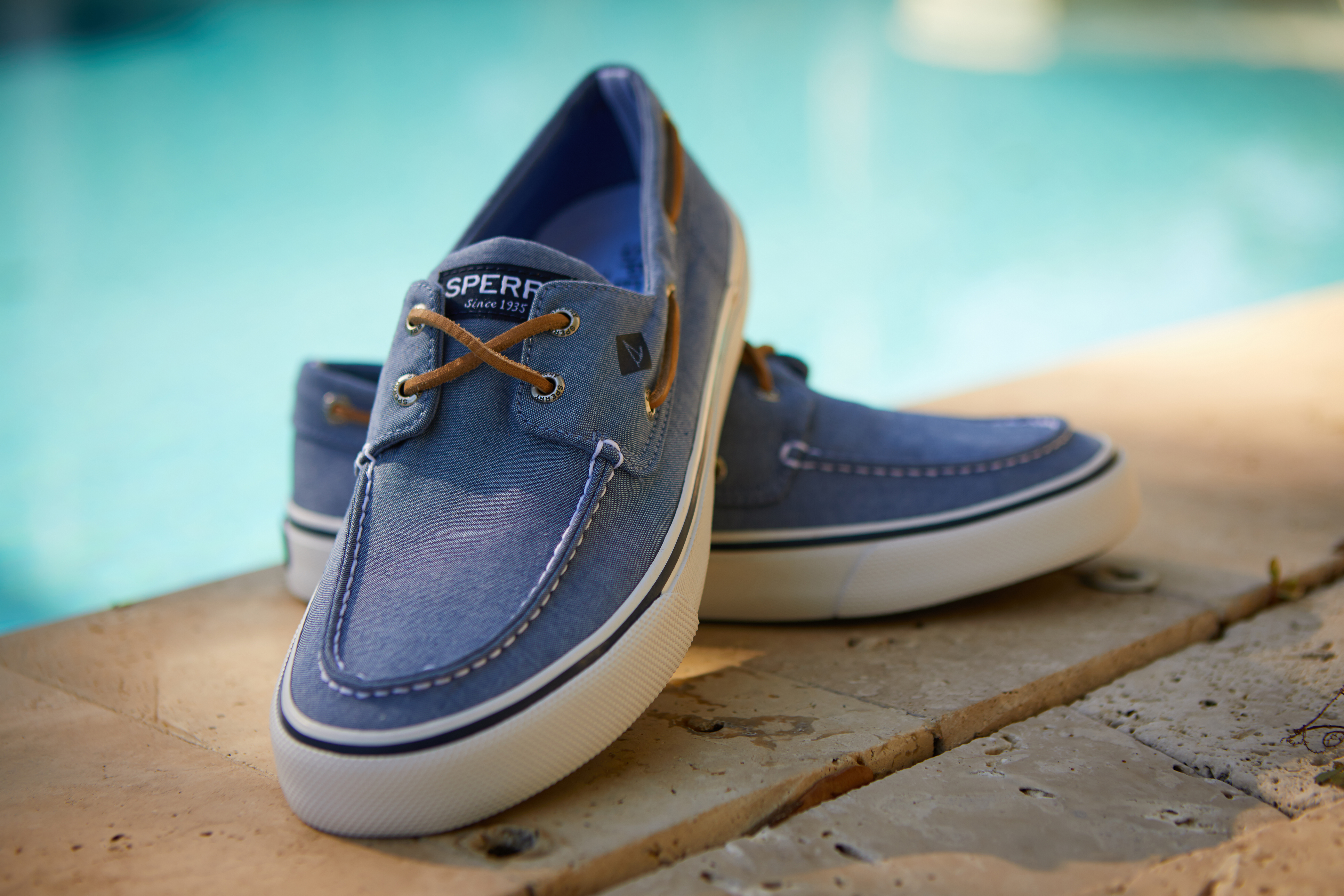 Blue and white Sperry Sneakers that has been style by a professional footwear photo stylist