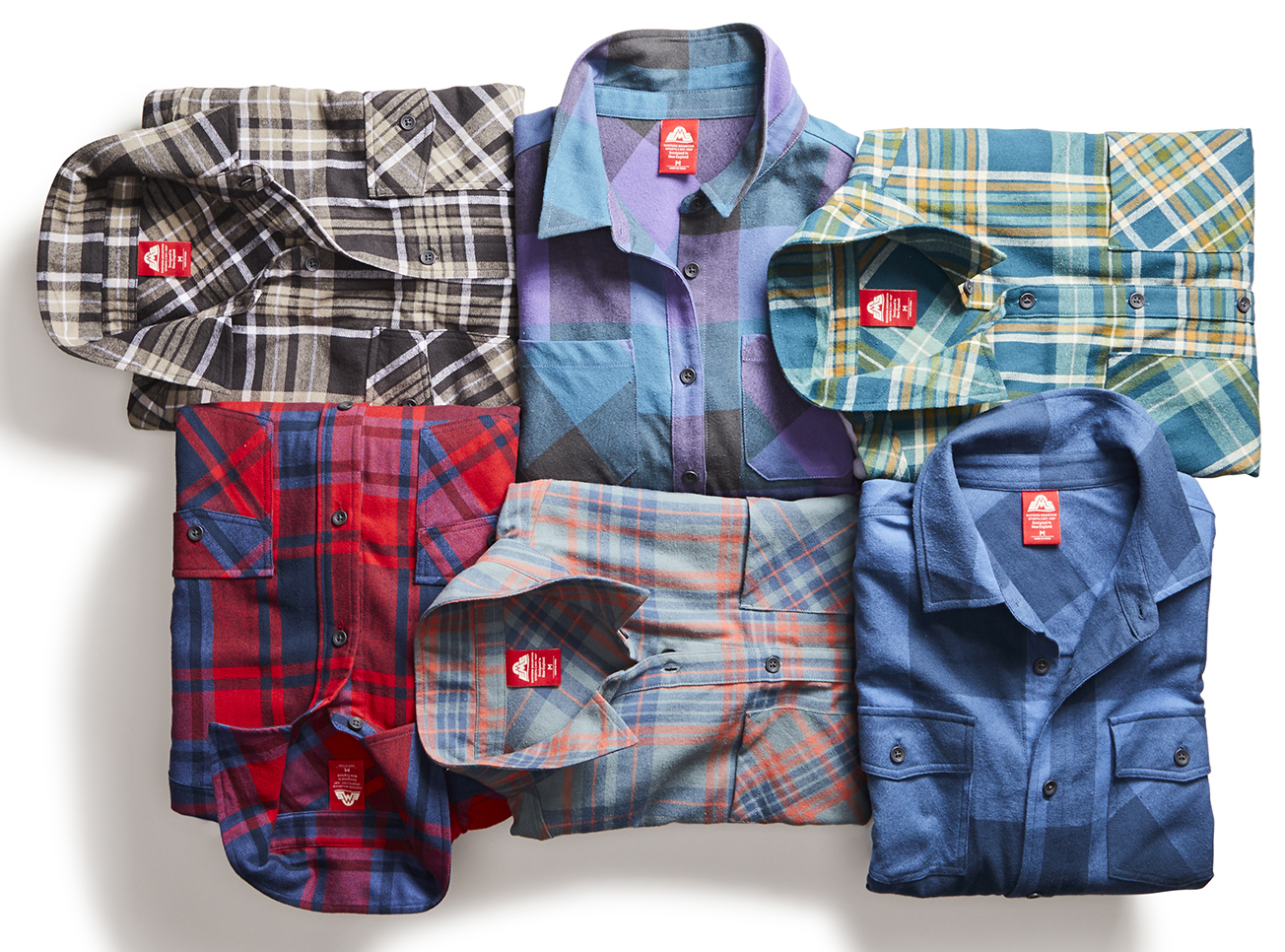 two long sleeved flannel shirts professionally displayed in a swirl pattern by an apparel photo stylist