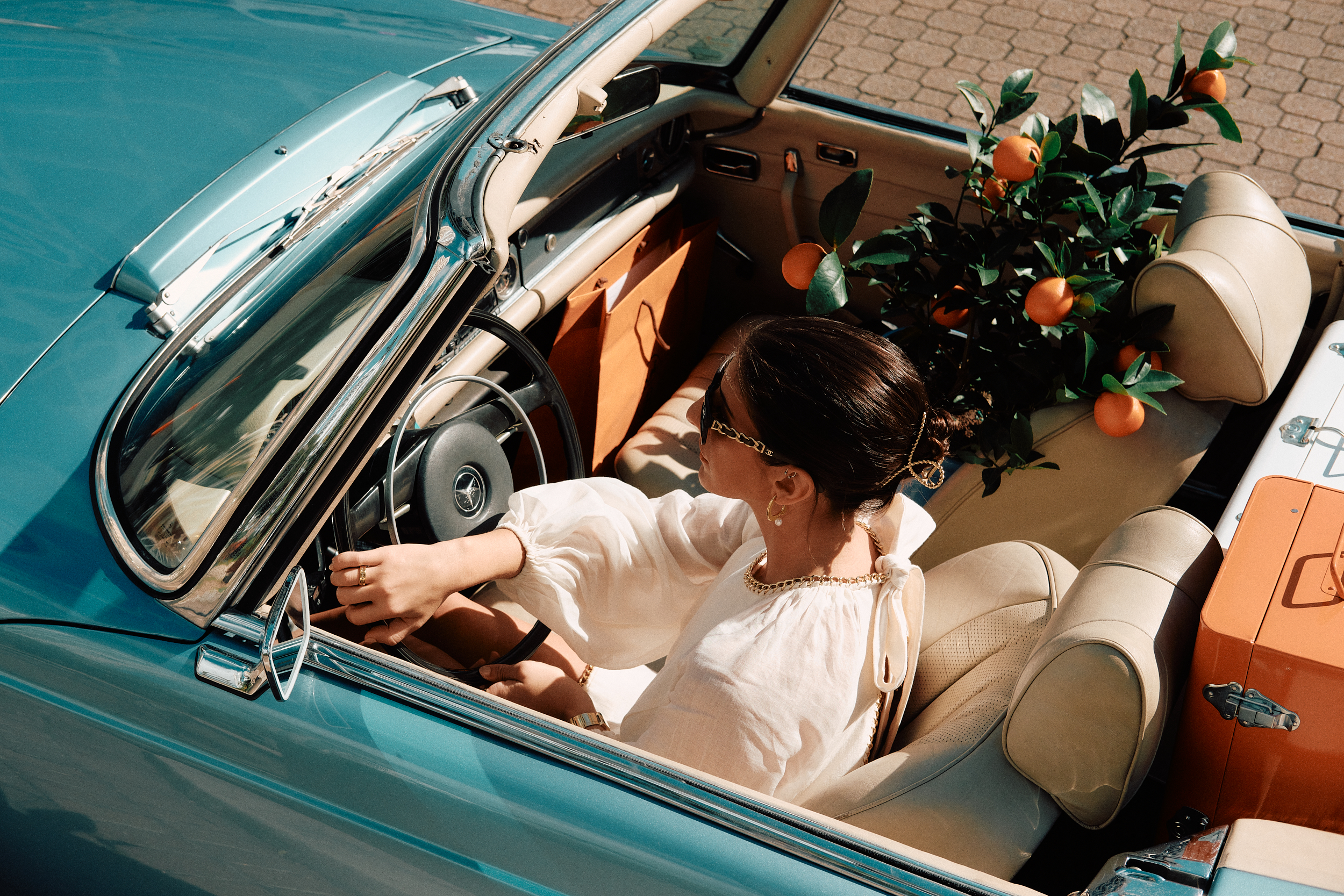 models posing for a photo shoot in a car on a set that was styled by a professional prop stylist