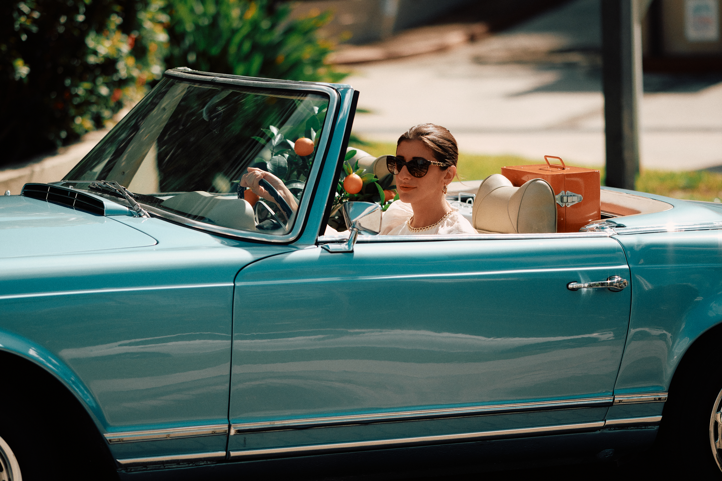 models posing for a photo shoot in a car on a set that was styled by a professional prop stylist