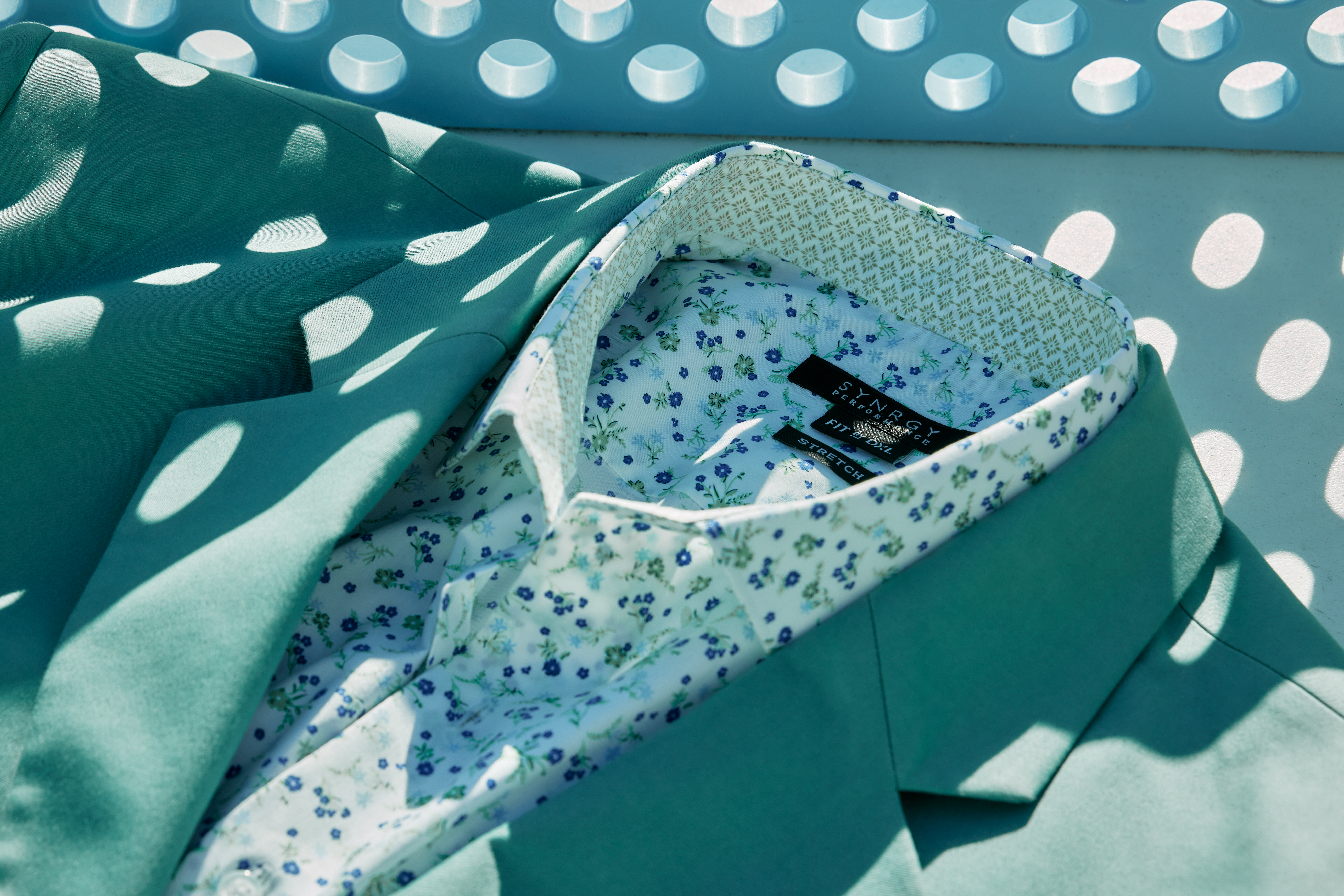 Men's dress jacket and shirt professionally displayed by an apparel photo stylist