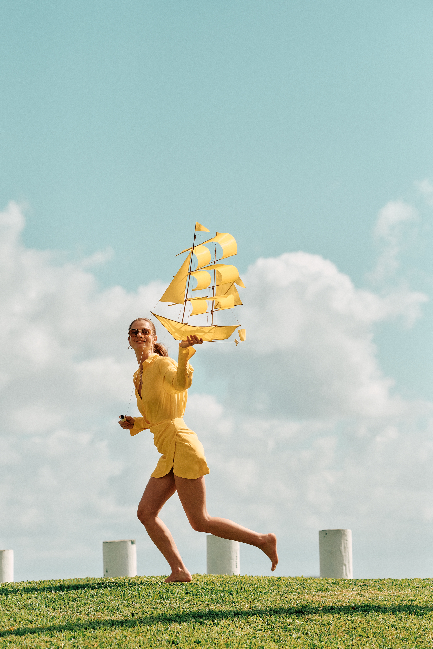 models posing for a photo shoot running through a field on a set that was styled by a professional prop stylist