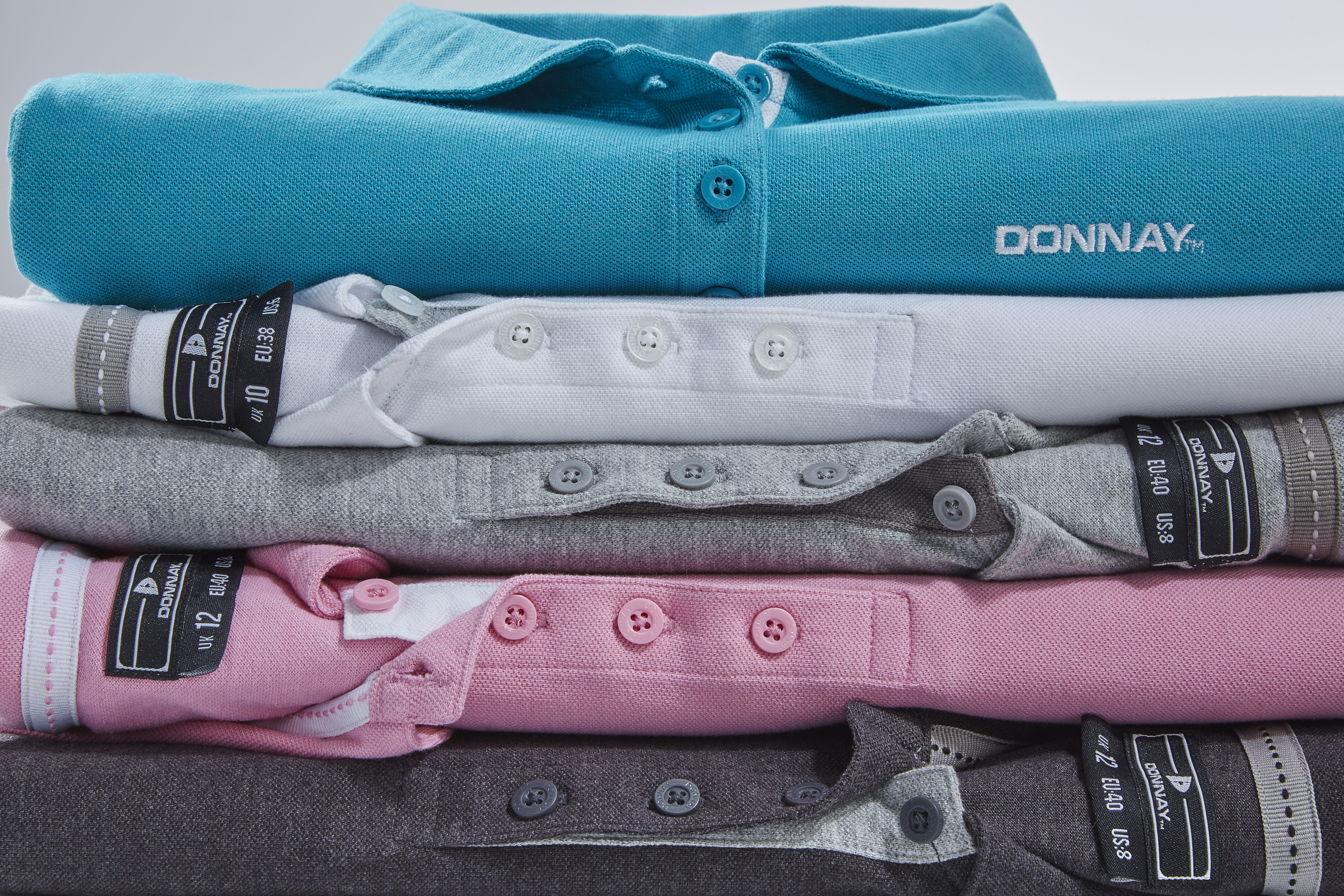 Mens golf shirts professionally displayed by an apparel stylist