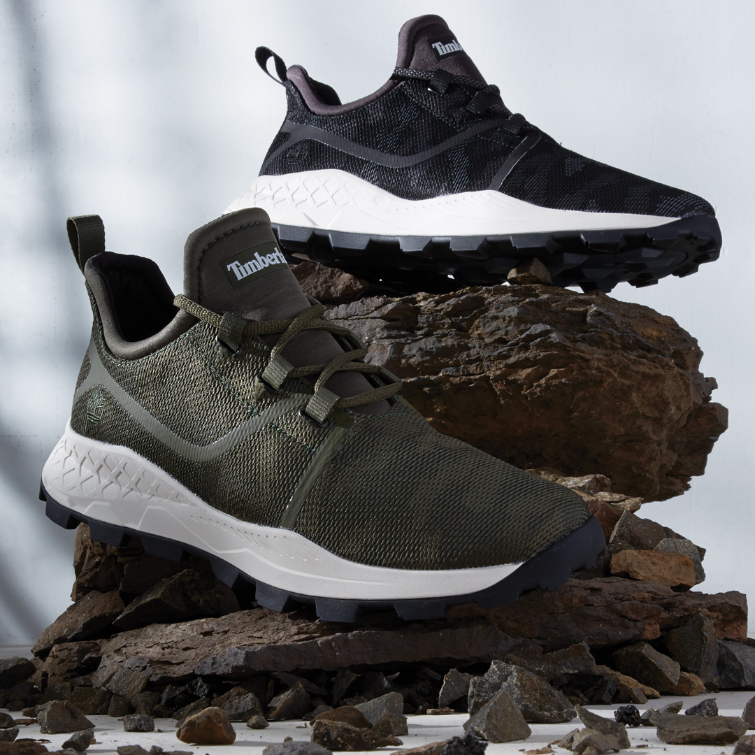 Timberland sneakers that have been styled on rocks by a footwear photo stylist