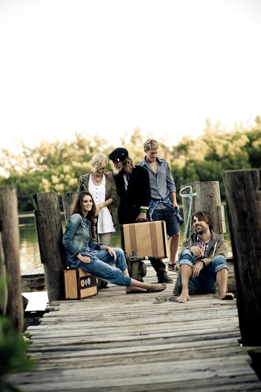 models posing on a dock for a photo shoot on a set that was styled by a professional prop photo stylist